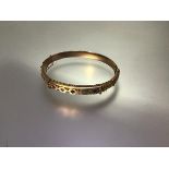 A late Victorian diamond and ruby-set gold bangle, in 9ct gold hallmarked for Birmingham 1898,