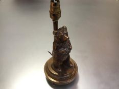 A cast polished bronze or brass novelty table lamp, modelled with a standing bear on a stepped