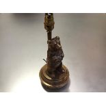 A cast polished bronze or brass novelty table lamp, modelled with a standing bear on a stepped
