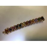 A 9ct gold bracelet set with specimen semi-precious stone cabochons, the twelve stones including