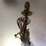 A brass table lamp formed from a Victorian swept sword hilt, with crowned cypher and sharkskin grip,