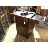 A George III mahogany washstand, the rectangular fold-out top opening to a fitted interior with