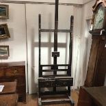 A large late 19th century pine artist's easel, of characteristic form, adjustable, fitted with two