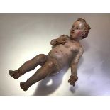 An 18th century painted gessoed terracotta creche figure of the Christ Child, possibly Neapolitan (