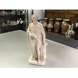 A 19th century parian figure of a standing cleric, in his right hand a scroll, his left resting upon