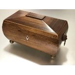 A handsome boxwood-lined rosewood tea caddy, second quarter, 19th century, of bombe sarcophagus