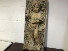 A large painted copper figural panel in high relief, 19th century, of a putto, emblematic of Autumn,