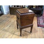 An early 19th century satinwood crossbanded mahogany cellarette, of square form, the hinged caddy