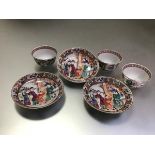 A set of three Chinese porcelain tea bowls and saucers, the bowls polychrome painted with figural