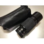 A Leica 70-210mm F4 Vario-Elmar-R lens (lens hood dented) in a soft carry case