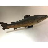 A carved and painted half block salmon (losses), with suspension loop. Length 55cm