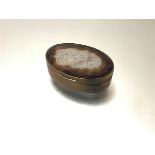 A 19th century gilt-metal mounted agate snuff box, oval, the mounts with engraved wavy bands.