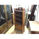 An Arts & Crafts open bookcase, the top shelf with pierced gallery over three further shelves and