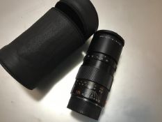 A Leica 135mm F 3.4 Apo-Telyt lens in a soft carry case