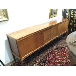 Bramin Mobler, a Danish teak sideboard, the long rectangular top above a central bank of four