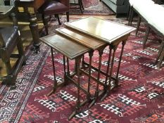 A set of three Regency style mahogany nesting tables, each with rectangular dished top, raised on