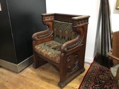 A 19th century Gothic Revival carved oak ecclesiastical throne chair, carved to the crest rail