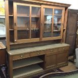 A large pine kitchen dresser and rack, the superstructure with moulded cornice above glazed