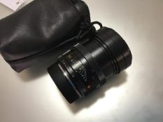 A Leica 90mm F2 Summicron-R lens, in a soft carry case