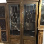 A 19th century glazed mahogany bookcase cabinet, with moulded cornice above a pair of astragal