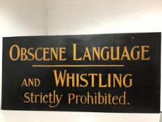 A double-sided painted wooden sign "Obscene Language / and Whistling / Strictly Prohibited" to