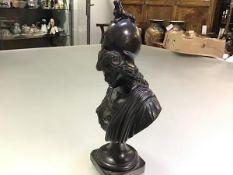 After the Antique, a patinated bronze desk bust of Athena, on an integral socle. 21cm