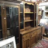 An 18th century style elm kitchen dresser and rack, the superstructure with central open shelves