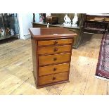 A mahogany collector's chest, of five graduated drawers beneath a rectangular top with moulded edge.