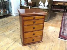 A mahogany collector's chest, of five graduated drawers beneath a rectangular top with moulded edge.