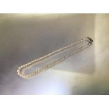 An emerald and diamond mounted single strand cultured pearl necklace, the graduated strand on an