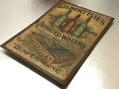 An early 20th century tin advertising sign for "Gilbert Rae's High Class Aerated Waters,