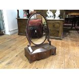 A George III string-inlaid and crossbanded mahogany toilet mirror, early 19th century, the oval