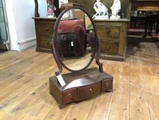 A George III string-inlaid and crossbanded mahogany toilet mirror, early 19th century, the oval