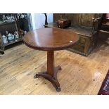 A Regency amboyna tripod table, the circular top with beaded rim on a concave tapering standard over