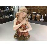 An Austrian pottery half figure of a girl, Ernst Wahliss Vienna, c. 1900, in the Art Nouveau