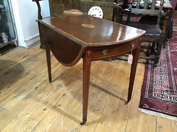 A George III satinwood crossbanded and inlaid mahogany Pembroke table, c. 1800, of characteristic