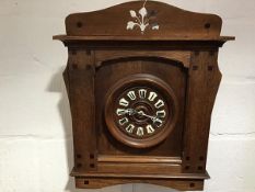 A Continental oak wall clock in the Secessionist taste, c. 1900, the oak dial with enamel Roman