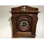 A Continental oak wall clock in the Secessionist taste, c. 1900, the oak dial with enamel Roman