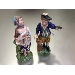 A pair of 19th century porcelain figures of a boy and girl, in 18th century style, she a
