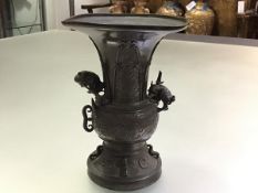 A Chinese patinated bronze vase, of Gu shape, with baluster body, applied with the figure of a