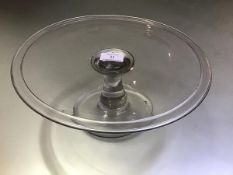 An 18th century glass tazza, the circular dish with broad folded rim on a baluster stem and circular