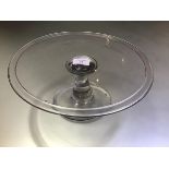 An 18th century glass tazza, the circular dish with broad folded rim on a baluster stem and circular