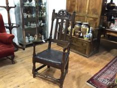 An oak elm open armchair in late 17th/early 18th century style, composed of some period elements,