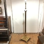 A brass Corinthian columnar standard lamp, the fluted column on a stepped square base supported on