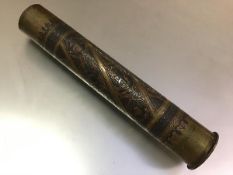 A World War I trench art artillery shell casing overlaid in copper with Islamic decoration and