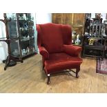 A George III style mahogany framed wing chair, late 19th century, with loose-cushioned seat,