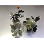 A group of Chinese jade and hardstone carvings comprising: a pomegranate with spinach jade leaves; a