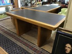 A 1940s oak writing table by Abbess, the rectangular top with tooled leather inset, raised on