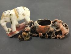 A carved soapstone elephant with painted decoration together with a soapstone brush wash and