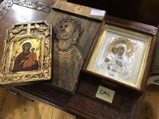 A group of three Russian icons, a metal framed icon in silver and gold coloured metals, a gold